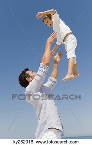 Man playing with his son on the beach View Large Photo Image Stock Photo - Man playing with his son on the beach. Fotosearch