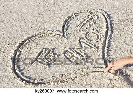 Person's hand drawing heart shape on the beach View Large Photo Image Stock Photo - Person's hand drawing heart shape on the beach. Fotosearch