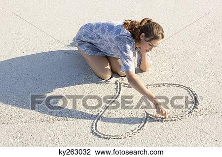 Woman drawing a heart shape on the beach View Large Photo Image Stock Image - Woman drawing a heart shape on the beach. Fotosearch