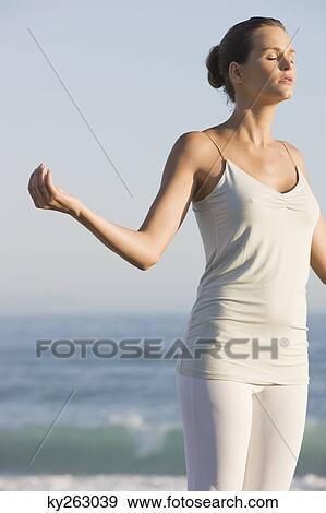 Woman practicing yoga on the beach View Large Photo Image Stock Photo - Woman practicing yoga on the beach. Fotosearch