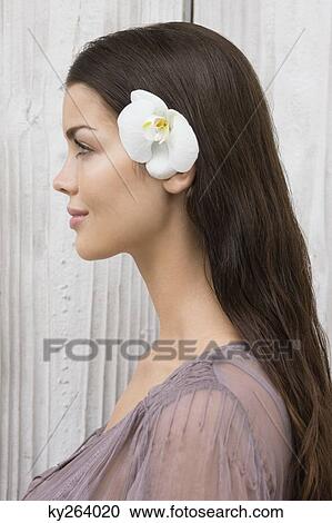 Close-up of a woman wearing flowers View Large Photo Image Stock Image - Close-up of a woman wearing flowers. Fotosearch