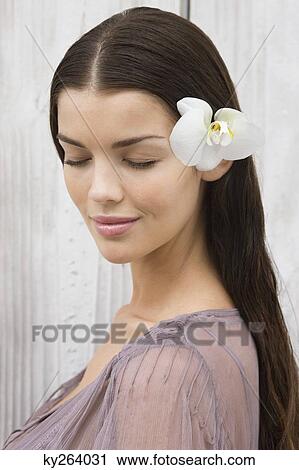 Close-up of a woman wearing flowers View Large Photo Image Stock Image - Close-up of a woman wearing flowers. Fotosearch