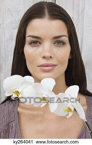 Portrait of a woman holding flowers View Large Photo Image Stock Image - Portrait of a woman holding flowers. Fotosearch