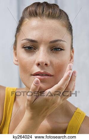 Woman applying moisturizer on her face View Large Photo Image Picture - Woman applying moisturizer on her face. Fotosearch
