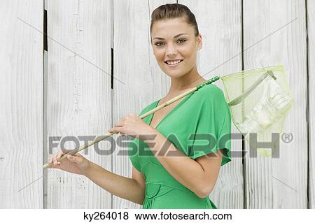Woman holding a butterfly net View Large Photo Image Stock Photo - Woman holding a butterfly net. Fotosearch