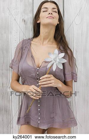 Woman holding a pinwheel and smiling View Large Photo Image Stock Image - Woman holding a pinwheel and smiling. Fotosearch