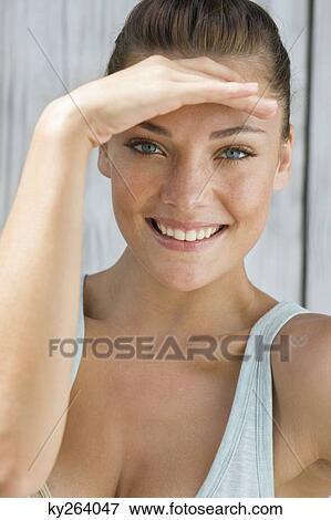 Woman shielding eyes View Large Photo Image Stock Photo - Woman shielding eyes. Fotosearch