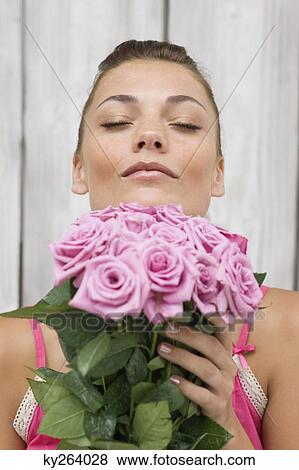 Woman smelling pink roses View Large Photo Image Stock Photo - Woman smelling pink roses. Fotosearch
