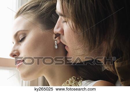 Stock Photography - Close-up of a couple romancing. Fotosearch