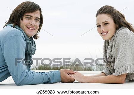 Couple holding hands of each other and smiling View Large Photo Image Stock Image - Couple holding hands of each other and smiling. Fotosearch