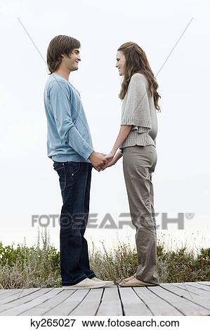 Couple holding hands of each other and smiling View Large Photo Image Stock Photo - Couple holding hands of each other and smiling. Fotosearch