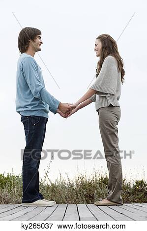 Couple holding hands of each other and smiling View Large Photo Image Stock Photo - Couple holding hands of each other and smiling. Fotosearch