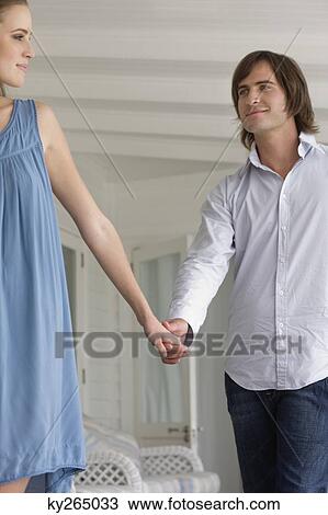 Couple holding hands of each other View Large Photo Image Stock Image - Couple holding hands of each other. Fotosearch