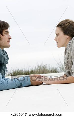 Stock Photo - Couple holding hands of each other. Fotosearch
