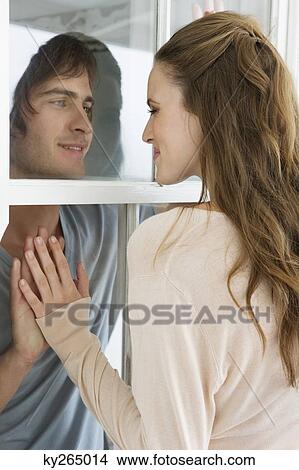 Couple looking at each other and smiling View Large Photo Image Picture - Couple looking at each other and smiling. Fotosearch