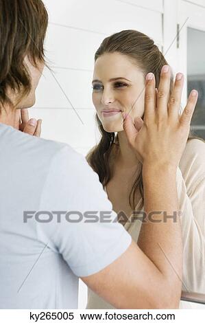 Couple looking at each other and smiling View Large Photo Image Stock Photography - Couple looking at each other and smiling. Fotosearch