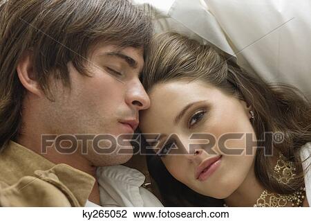 Couple resting on the bed View Large Photo Image Stock Image - Couple resting on the bed. Fotosearch