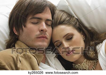 Couple resting on the bed View Large Photo Image Stock Photograph - Couple resting on the bed. Fotosearch