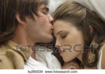 Couple romancing on the bed View Large Photo Image Picture - Couple romancing on the bed. Fotosearch