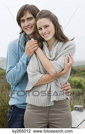Couple standing together and holding each other's hand View Large Photo Image Stock Image - Couple standing together and holding each other's hand. Fotosearch