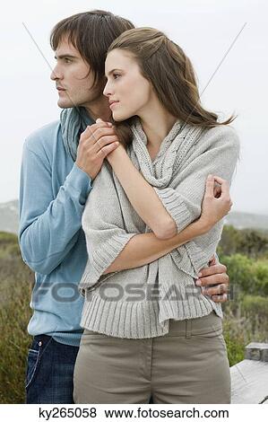 Couple standing together and holding each other's hand View Large Photo Image Stock Photo - Couple standing together and holding each other's hand. Fotosearch