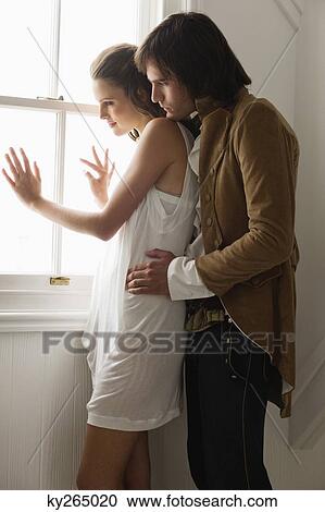 Man embracing a woman from behind View Large Photo Image Stock Image - Man embracing a woman from behind. Fotosearch