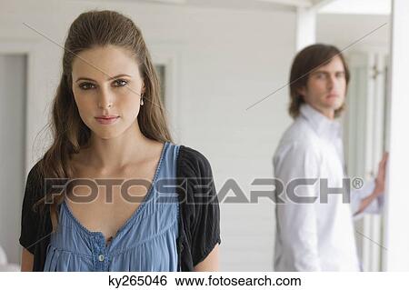 Portrait of a woman with a man in the background View Large Photo Image Stock Photograph - Portrait of a woman with a man in the background. Fotosearch