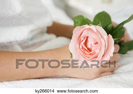 Close-up of a flower girl holding a flower View Large Photo Image Picture - Close-up of a flower girl holding a flower. Fotosearch