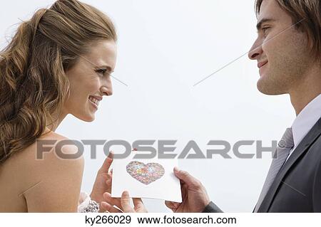 Stock Photo - Groom giving a gift to a bride. Fotosearch