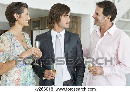 Man drinking champagne with his parents View Large Photo Image Stock Photo - Man drinking champagne with his parents. Fotosearch