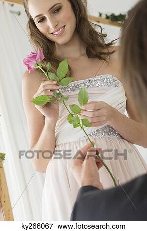Man giving a flower to a woman in the bedroom View Large Photo Image Stock Photo - Man giving a flower to a woman in the bedroom. Fotosearch