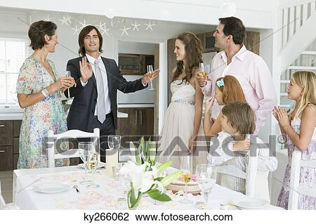 Newlywed couple enjoying with guests in a party View Large Photo Image Stock Image - Newlywed couple enjoying with guests in a party. Fotosearch