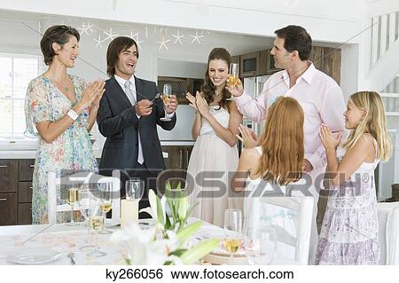 Newlywed couple enjoying with guests in a party View Large Photo Image Stock Photograph - Newlywed couple enjoying with guests in a party. Fotosearch