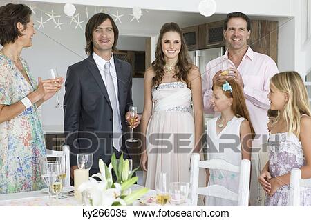 Newlywed couple enjoying with guests in a party View Large Photo Image Stock Photography - Newlywed couple enjoying with guests in a party. Fotosearch