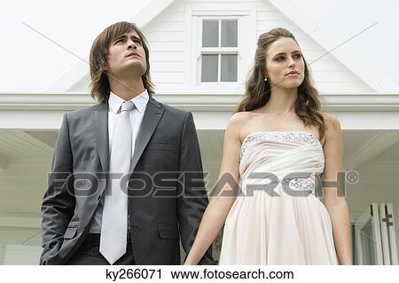 Newlywed couple in front of a house View Large Photo Image Stock Image - Newlywed couple in front of a house. Fotosearch