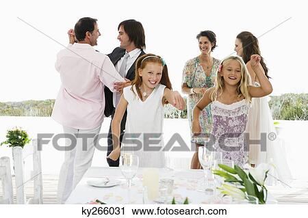Newlywed couple with guests in a wedding party View Large Photo Image Stock Image - Newlywed couple with guests in a wedding party. Fotosearch