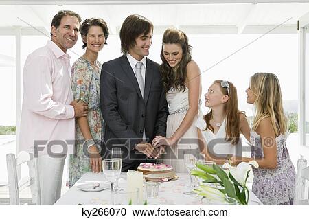 Newlywed couple with guests in a wedding party View Large Photo Image Stock Image - Newlywed couple with guests in a wedding party. Fotosearch