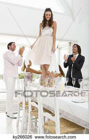 Stock Photograph - Newlywed couple with guests in a wedding party. Fotosearch