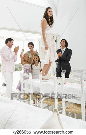 Stock Photography - Newlywed couple with guests in a wedding party. Fotosearch