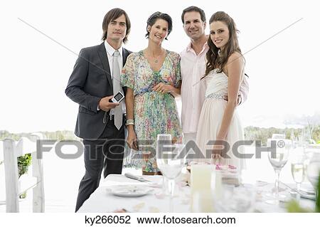 Newlywed couple with their parents View Large Photo Image Stock Image - Newlywed couple with their parents. Fotosearch