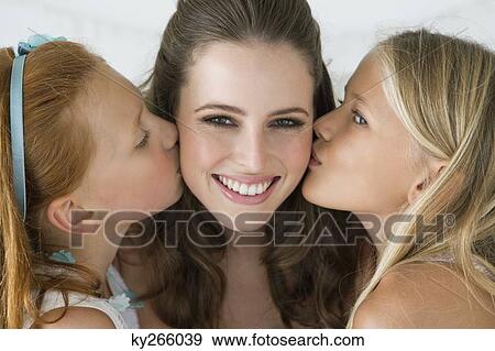 Two girls kissing bride on cheeks View Large Photo Image Stock Photo - Two girls kissing bride on cheeks. Fotosearch