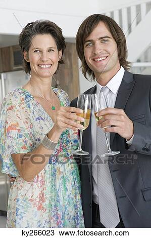 Woman and her son drinking champagne View Large Photo Image Stock Image - Woman and her son drinking champagne. Fotosearch
