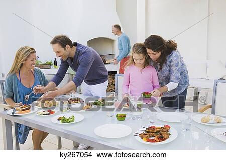 Family having breakfast at the dining table View Large Photo Image Picture - Family having breakfast at the dining table. Fotosearch