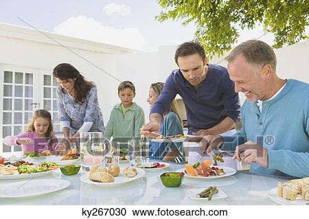 Family having breakfast at the dining table View Large Photo Image Stock Image - Family having breakfast at the dining table. Fotosearch