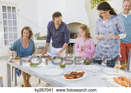 Stock Image - Family having breakfast at the dining table. Fotosearch