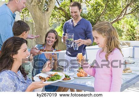Family having breakfast at the dining table View Large Photo Image Stock Photo - Family having breakfast at the dining table. Fotosearch