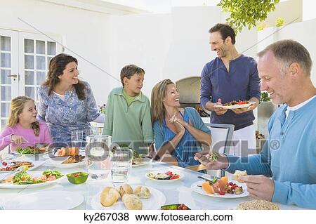 Family having breakfast at the dining table View Large Photo Image Stock Photo - Family having breakfast at the dining table. Fotosearch