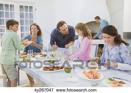 Family having breakfast at the dining table View Large Photo Image Stock Photo - Family having breakfast at the dining table. Fotosearch