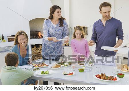Family having breakfast at the dining table View Large Photo Image Stock Photograph - Family having breakfast at the dining table. Fotosearch