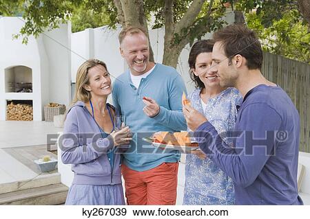 Four friends eating fruits and having fun View Large Photo Image Stock Photo - Four friends eating fruits and having fun. Fotosearch